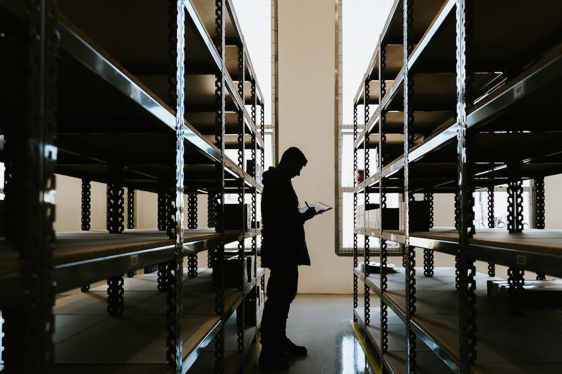 Free Person With Clipboard in Warehouse Stock Photo